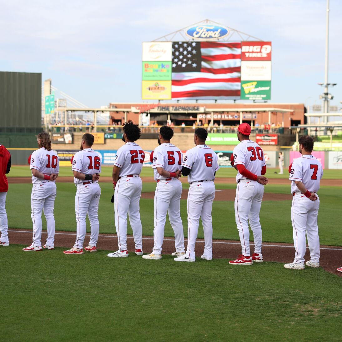 Louisville Bats stand on foul line.JPG